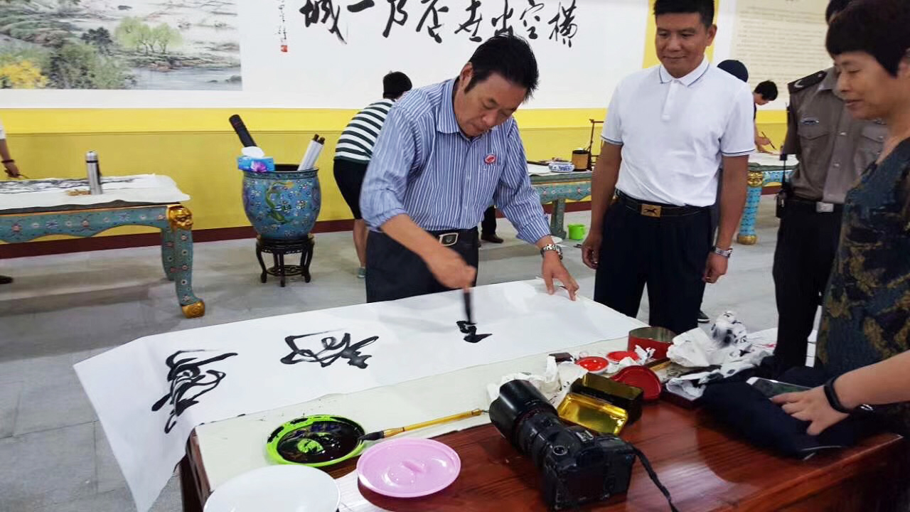 馮雪林在浙江橫店影視城現(xiàn)場(chǎng)創(chuàng)作寧?kù)o致遠(yuǎn)行書(shū)書(shū)法作品